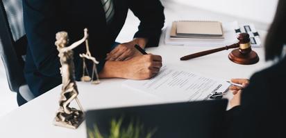 lawyer or judge is giving legal advice. to explaining about consultation terms and conditions to businessmen before signing on contract at a law firm photo