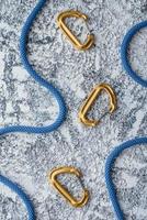 Captured at daytime. Natural lighting. Isolated photo of climbing equipment. Part of carabiner lying on the white and grey colored table