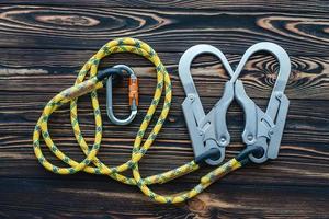 For people that want extreme. Isolated photo of climbing equipment. Parts of carabiners lying on the wooden table