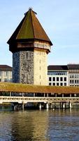 close up tower and wooden Chapel Bridge in Lucerne photo