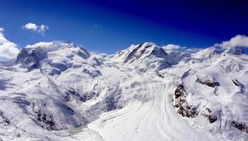 snow alps mountains view and blue sky photo