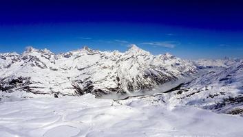 snow alps mountains view and blue sky photo