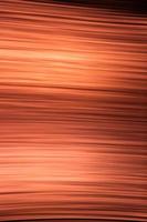 Abstract orange-black background of thin wavy lines photo