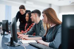 Everyone doing his work. Group of young people in casual clothes in the modern office photo