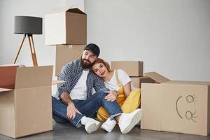 Job almost done. Happy couple together in their new house. Conception of moving photo