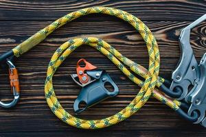 Quality material. Isolated photo of climbing equipment. Parts of carabiners lying on the wooden table