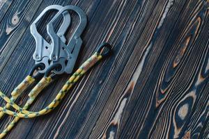 Clean surface. Isolated photo of climbing equipment. Part of carabiner lying on the wooden table