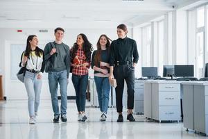 Unity of people. Group of young workers walking in the office at their break time photo