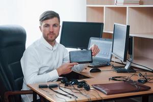 New equipment. Polygraph examiner works in the office with his lie detector photo