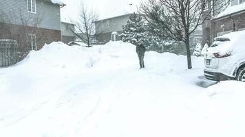 Man struggles to walk through blustery blizzard in high winds video