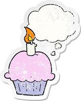 cartoon birthday cupcake and thought bubble as a distressed worn sticker vector