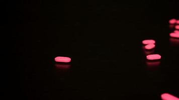 Sliding across pills spilled on table out of prescription pill bottle