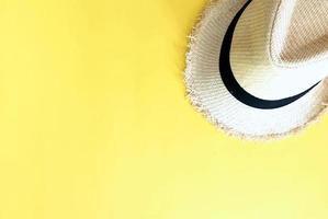 Woven hat on pastel yellow color background summer horizontal photo