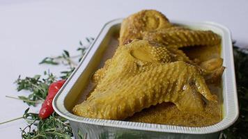 Indonesian food, chicken, vegetables, yellow seasoning photo