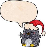 cartoon penguin wearing christmas hat and speech bubble in retro texture style vector