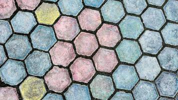 Colorful floor motif of hexagon cement bricks for your design concept.  Geometric background pattern of rough cement floor. Paving block motif. Colorful hexagon background pattern. photo