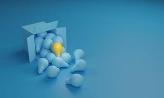 Yellow light bulb glows on the many blue light bulbs coming out of a cardboard box photo