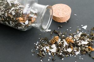 dry tea with coconut in a glass jar photo