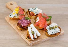 Tapas with cheese, salami and salmon photo
