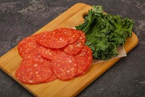 Italian spycy pepperoni sausage slices photo