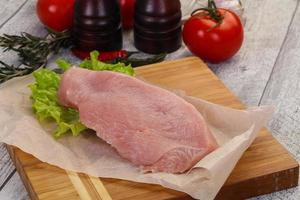 Raw Turkey steak served rosemary photo