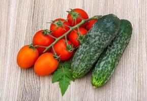 Cucumbers and tomatoes on the branch photo