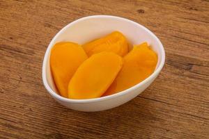 Sweet mango slices in syrop photo