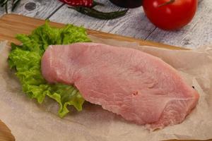 Raw Turkey steak served rosemary photo