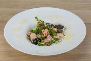Rucola with squid salad photo
