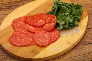 Italian spycy pepperoni sausage slices photo