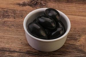 Pickled black olives in the bowl photo