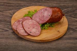 Smoked ham sausage with spices photo