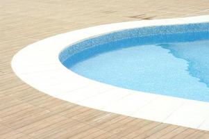 Swimming pool with clean blue water under the bright sunlight. photo