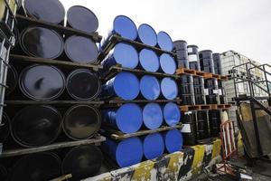 Oil barrels blue and black or chemical drums horizontal stacked. photo