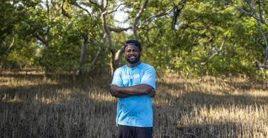 Portrait of African American volunteer man enjoy charitable social work outdoor in mangrove planting project photo