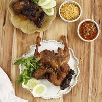 Bebek Goreng, Deep Fried Duck. Popular Indonesian Menu Served with Fresh Green Vegetables and Sambal photo