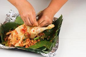 Ayam Betutu. Balinese Roast Chicken Stuffed with Cassava Leaves. photo