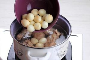 Add Boiled Quail Egg, Cooking Opor Ayam Indonesian Chicken Curry with Tofu adn Quail Egg, Cooking Process in the Kitchen. photo