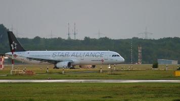 DUSSELDORF, GERMANY JULY 23, 2017 - Turkish Airlines Airbus A321 TC JRL in Star Alliance livery taxiing after landing, slow motion. Dusseldorf airport video