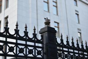 The iron fence of the government building in the park Russia. Iron pins on the fence. photo