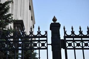 The iron fence of the government building in the park Russia. Iron pins on the fence. photo