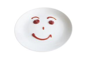 Portrait of white plate with smiley face photo