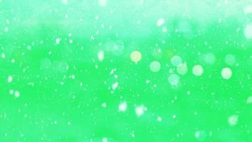 Animation white snow falling on green background. video