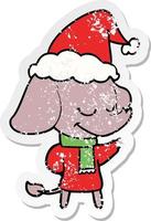 distressed sticker cartoon of a smiling elephant wearing scarf wearing santa hat vector