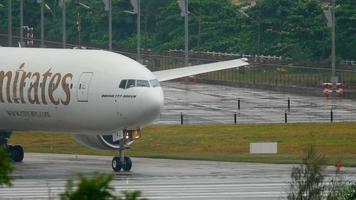 PHUKET, THAILAND DECEMBER 2, 2016 - Emitates Boeing 777 A6 EPJ taxiing before departure from Phuket airport. video