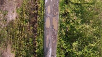 Aerial top down descending broken rural road video