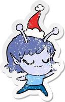 smiling alien girl distressed sticker cartoon of a wearing santa hat vector