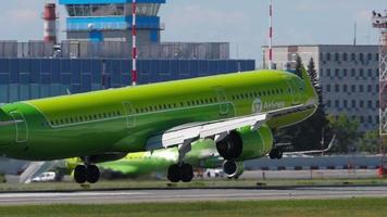 NOVOSIBIRSK, RUSSIAN FEDERATION JUNY 12, 2022 - Passenger airplane of S7 Airlines landing and braking at Tolmachevo airport. Cinematic footage aircraft slowly flies. Travel concept
