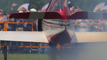 NOVOSIBIRSK, RUSSIAN FEDERATION JULY 28, 2019 - pilot of YAK 52 sport plane of Aerobatic group  Barses -snow leopards- greets airshow viewers. Airshow at the Mochische aerodrome -UNNM- video