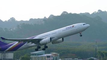 PHUKET, THAILAND NOVEMBER 27, 2017 - Thai Airways Airbus A330 HS TBG taking off from Phuket airport and climbing in the air. video